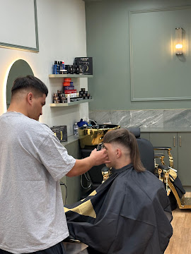 Barber cutting a client's hair with clippers at Signature Hair Styles