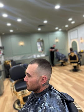 Short buzz cut with a clean taper through the sides at Signature Hair Styles